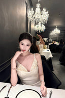Vogsion Aurelia white corset dress with 3D floral tulle skirt on customer at luxury dinner, 2026 fashion trends.