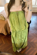 VOGSION Luna Lace Bandeau Gown in Pistachio green lace, featuring a strapless plunging neckline and braided detailing, modeled by a Vogsion custome
