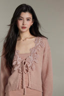 Side view of Vogsion powder pink matching knit set: lace-trimmed cardigan and flowy maxi skirt on genuine customer, soft knit fabric, elegant co-ord for spring summer 2026, real woman styling