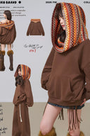 Brown hoodie with patterned hood worn by a person, displayed against a plain background.