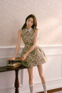 Model wearing Vogsion La Fleur de Mémoire vintage floral mini dress with white collar, soft lighting and romantic Parisian aesthetic