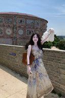 Vogsion Dawning Floral Corset Midi Dress featuring a blue and white boho floral pattern and tie straps, shown on a customer in a scenic vacation setting