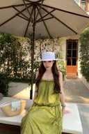 VOGSION Luna Lace Bandeau Gown in Pistachio green lace, featuring a strapless plunging neckline and braided detailing, modeled by a Vogsion custome