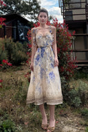 Vogsion Dawning Floral Corset Midi Dress featuring a blue and white boho floral pattern and tie straps, shown on a customer in a scenic vacation setting