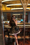 Woman wears Vogsion Shush Trong Renaissance Stiff Wool-Lace Coquette Dress taking a mirror selfie in a restaurant setting