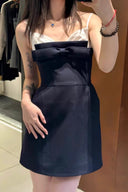 Person wearing Vogsion Antoinette Structured Bow Tailored Mini Dress with a large bow in a store setting