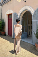 Back view of VOGSION Sahara Mirage off shoulder long sleeve formal maxi dress with flowing draped back detail