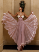Blush pink petite wedding guest ruffle dress with ruched bodice and white lace bust detail