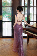 Woman in a Vogsion "Midnight Butterfly" Iridescent Sequin Backless Evening Gown standing by a piano in a room with large windows.