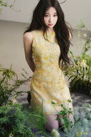 Vogsion Aurelia Soleil Floral Mini Dress worn by a normal customer in a botanical studio, high-end A-line silhouette, luxury yellow floral fashion, authentic customer photo.