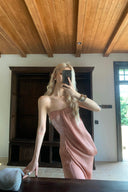 Woman in a Vogsion Strapless Twist Knot Satin Draped Maxi Dress taking a mirror selfie in a room with wooden ceiling and dark wooden cabinet.
