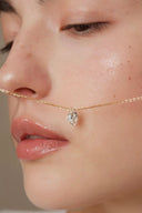     Vogsion Minuit Éclat dainty oval moissanite pendant necklace on gold-tone chain styled on natural customer-style model.