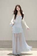 Vogsion customer wearing the Céleste light blue floral tiered tulle maxi dress with sheer skirt and romantic aesthetic for high-end summer fashion.