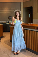 Woman in a Vogsion L’Avenir Polka-Dot Lace Ruffle Maxi Dress in Powder Blue holding a drink at a Starbucks Reserve Bar.