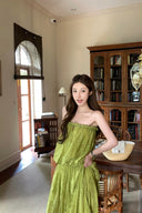 VOGSION Luna Lace Bandeau Gown in Pistachio green lace, featuring a strapless plunging neckline and braided detailing, modeled by a Vogsion custome