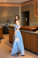 Woman in a blue polka dot dress standing in a Starbucks Reserve Bar.