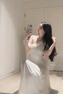 Vogsion Signature Pleated Draped Shoulder Dress in Ivory – elegant white pleated draped shoulder maxi dress worn by real customer, off shoulder formal evening gown 2026 trend