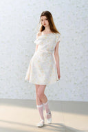 Romantic off-shoulder floral mini dress by Vogsion, pastel flower pattern, A-line silhouette, soft feminine French style perfect for spring and summer days.