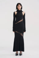 Vogsion x Nophora Obsidian Ecliptic Avant-Garde Maxi Gown worn by a customer, featuring black turtleneck, shoulder cut-outs, and diagonal sheer mesh panels.