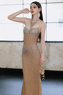 Woman in a Vogsion Sparkly Crystal Rhinestone Nude Mermaid Halter Prom Dress with a neutral background
