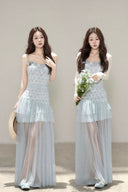 Vogsion customer wearing the Céleste light blue floral tiered tulle maxi dress with sheer skirt and romantic aesthetic for high-end summer fashion.