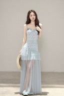 Vogsion customer wearing the Céleste light blue floral tiered tulle maxi dress with sheer skirt and romantic aesthetic for high-end summer fashion.