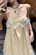 Vogsion Santorini Scalloped Lace Maxi Dress in cream, featuring delicate floral lace bust detailing and a fluid, floor-length silhouette.