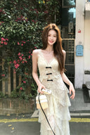 Vogsion Beige Floral Bow V-Neck Dress worn by a customer, featuring tiered floral lace, high slit, and French-inspired aesthetic