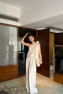 Woman styling the VOGSION Élan Quiet Luxury Linen Set with a structured handbag, featuring breathable premium linen, an elegant floral shoulder accent, and flowing wide-leg pants for an elevated minimalist wardrobe.