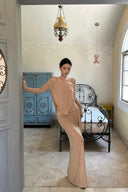 Elegant beige off shoulder draped maxi dress with long sleeves for formal wedding guest and luxury resort occasions
