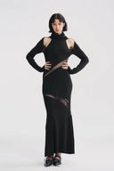 Vogsion x Nophora Obsidian Ecliptic Avant-Garde Maxi Gown worn by a customer, featuring black turtleneck, shoulder cut-outs, and diagonal sheer mesh panels.