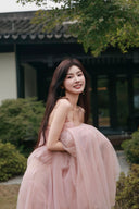 Vogsion soft pink corset gown with lace bodice and flowy tulle skirt smiling shot