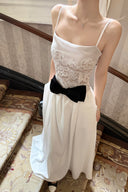 Vogsion Élodie Lace Corset Bow Satin Maxi Dress on a staircase