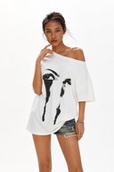 Petite off shoulder white graphic t-shirt for women featuring an oversized loose fit, abstract eye print and breathable cotton fabric. A versatile summer top that can be worn off the shoulder or as a boat neck, flattering for petite frames, short torsos and everyday streetwear outfits.