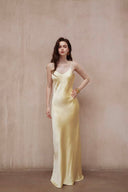 Vogsion Butter Yellow Satin Backless Slip Maxi Dress with Rosette Detail – full-length front view of satin slip maxi gown