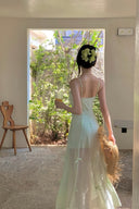 Convertible maxi to mini dress in pastel yellow and mint green, with delicate ribbon details, designed for versatile styling across vacation, date night, and event fashion.