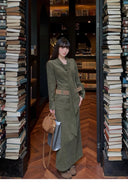 Stylish corduroy maxi dress in moss green with waist belt and bow tie neckline, elegant autumn long sleeve dress ideal for fall bookstore visits, winter city chic looks, and vintage fashion outfits.