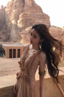 Vogsion Spring Oath Embroidered Tulle Gown in champagne nude featuring floral corset bodice and flowing pleated tulle skirt, styled for destination wedding and evening gala elegance