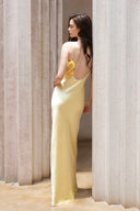Vogsion Butter Yellow Satin Backless Slip Maxi Dress with Rosette Detail – full-length back view highlighting open back and smooth drape