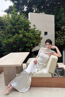 Vogsion Celeste Ivory Satin Cape Gown – outdoor lounge shot showing full-length satin column and cape detail