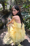 Vogsion Luna Fanned Maxi Dress in Spliced Floral worn by normal customer not professional model | Spring 2026 Kindred Spirit Collection tiered ruffle halter maxi dress in yellow/pink – perfect boho wedding guest look