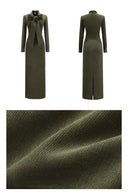 Olive green corduroy bow tie maxi dress with long sleeves and waist belt, full length fall winter dress with back slit, close up texture showing thick corduroy fabric ideal for autumn and winter wear.