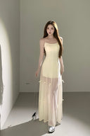 Elegant sheer maxi dress with bow ties that transform into midi and mini lengths, perfect as a cocktail dress, vacation outfit, or wedding guest dress.