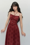 Close up of crimson embroidered maxi dress with ruched bodice and button details, sleeveless fall fashion long dress with vintage inspired design.