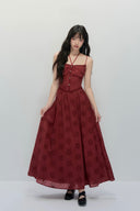 Model wearing deep red embroidered cut-out maxi dress with corset bodice and flowy skirt, chic autumn outfit for fall fashion trends and winter gatherings.