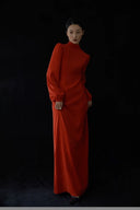 Woman wearing a red dress against a black background