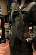 Close up detail of corduroy bow tie maxi dress in moss green with structured waist belt, showcasing autumn and winter fashion texture, elegant fall outfit design, and vintage inspired long sleeve dress.