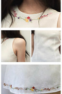 Front view of Vogsion sleeveless mini dress, 55% linen 45% cotton blend, floral embroidered details, natural fit on everyday woman.