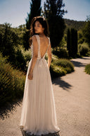 Full-length back view of Vogsion Amber Light Lace Spliced Open Back Tie Strap Maxi Dress with open back lace design, adjustable tie waist, floor-length chiffon silhouette, elegant ivory formal dress, destination wedding guest dress, timeless garden party maxi dress.