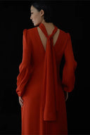 Red dress with a tie detail on a black background